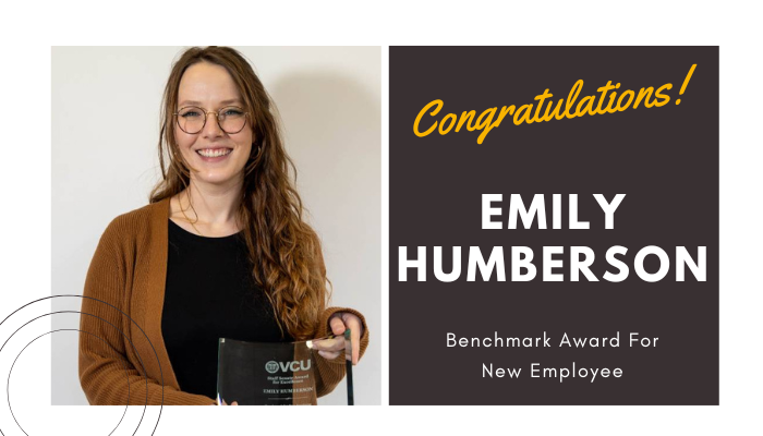 emily humberson holding her award / congratulations benchmark for new employee