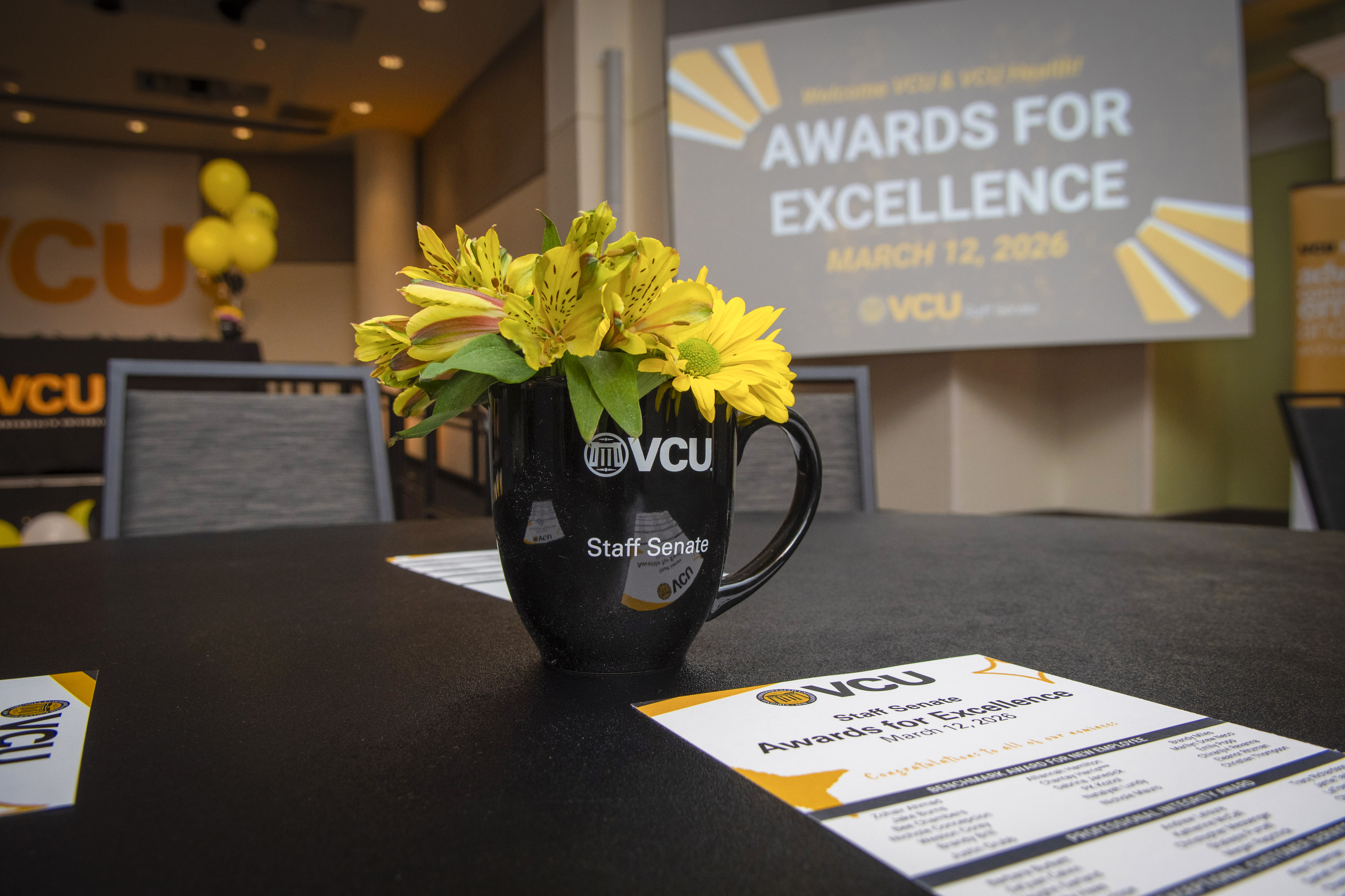 Flowers in awards cup on a table