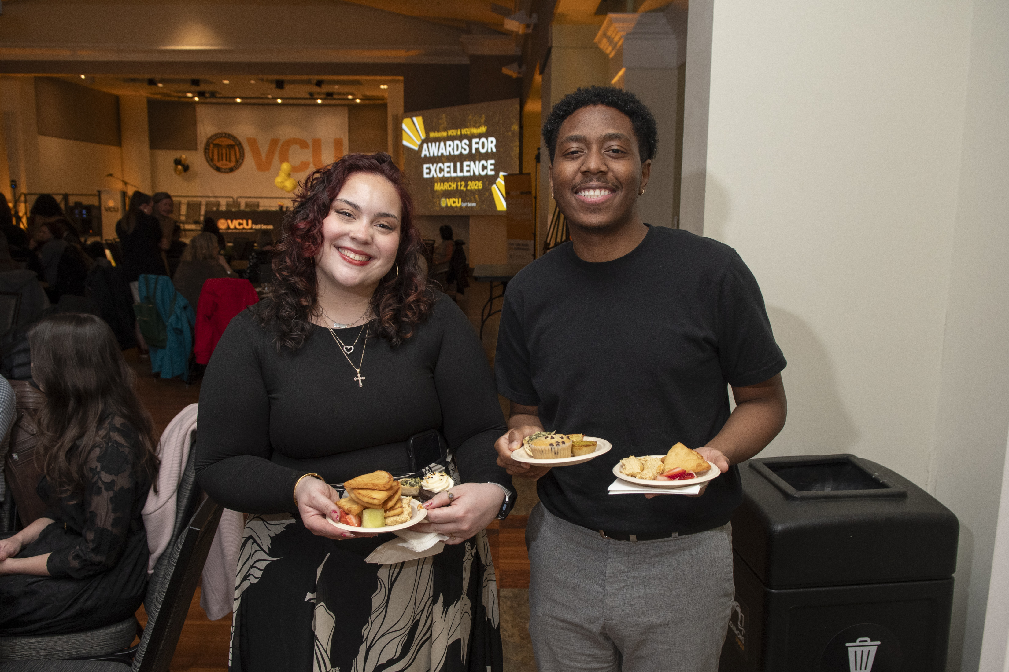 Attendees posing holding food