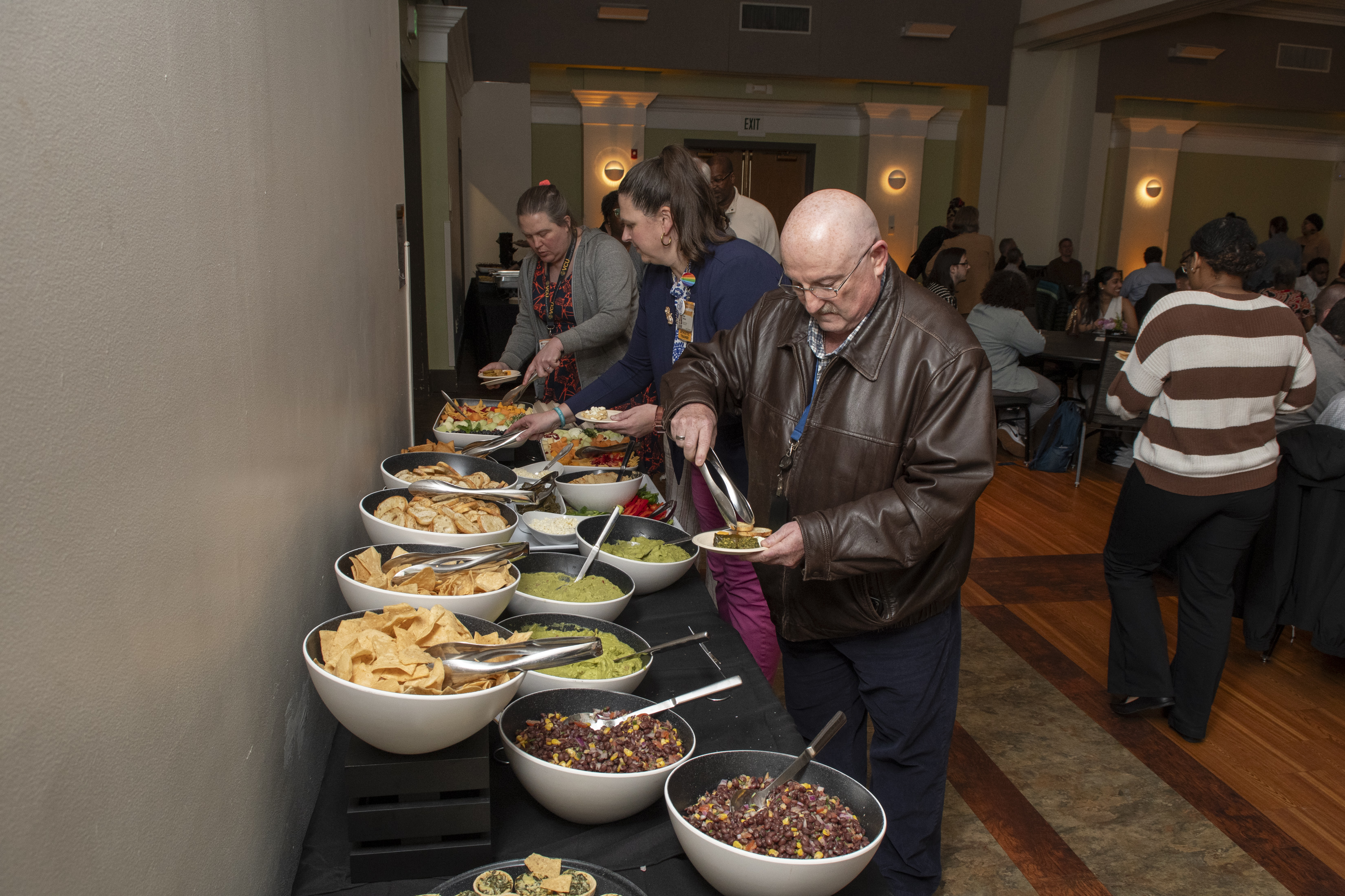 Attendees getting food and refreshments